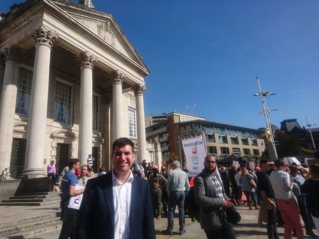 Richard Burgon (East Leeds MP) in Millenium Square with crowds in the background