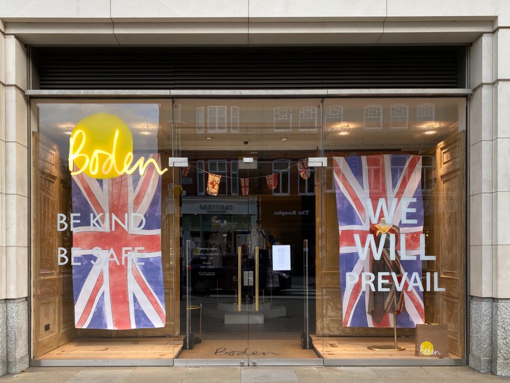 Boden storefront with the words "Be kind, be safe" and "We will prevail"